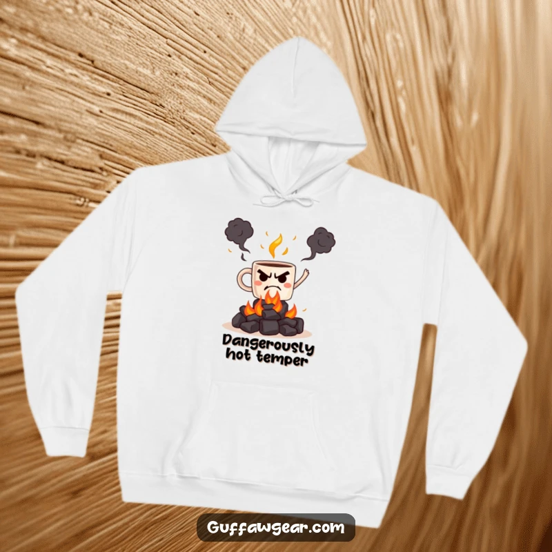 Funny hoodie with a grumpy coffee mug juggling flaming hot coals, a hilariously dangerous and cozy design.