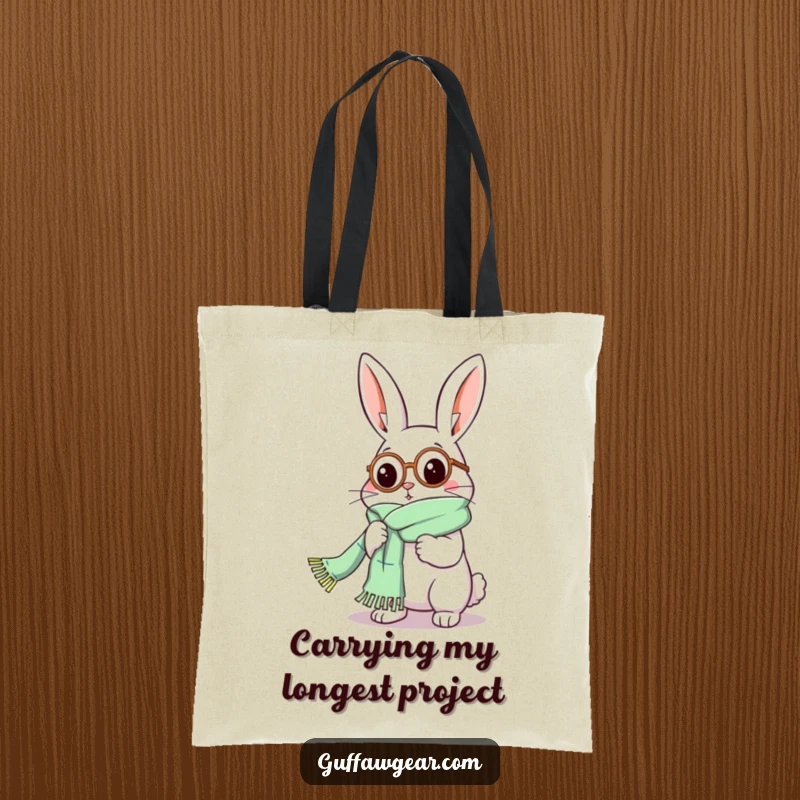Funny Rabbit Tote Bag: A rabbit in a monocle comically struggles with a scarf that is excessively long while knitting.